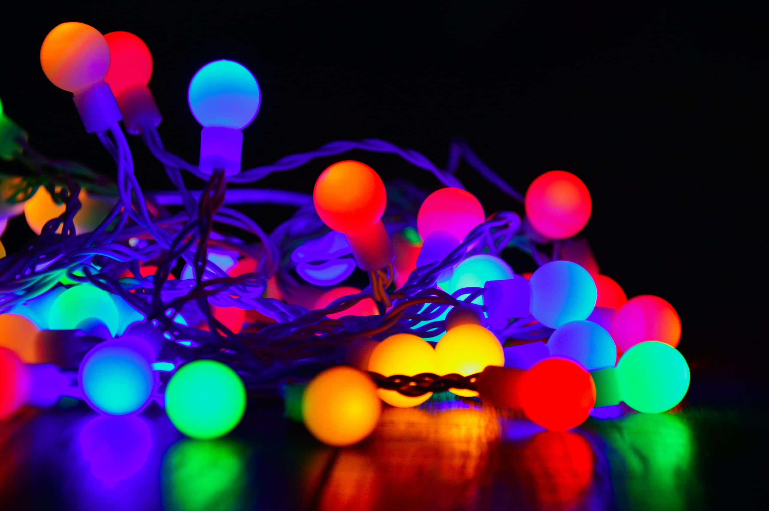 pictured is a lighted set of round old style christmas bulbs of many colors