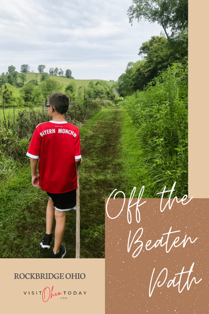 pin image with boy walking away on green path text overlay saying off the beaten path