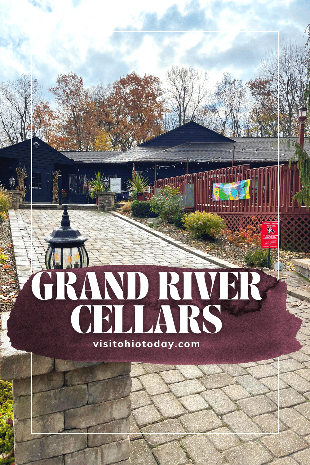 text overlay: Grand River Cellars with a picture of the red winery in the back ground. Paver stones leading up to the door.