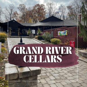 text overlay: Grand River Cellars with a picture of the red winery in the back ground. Paver stones leading up to the door.