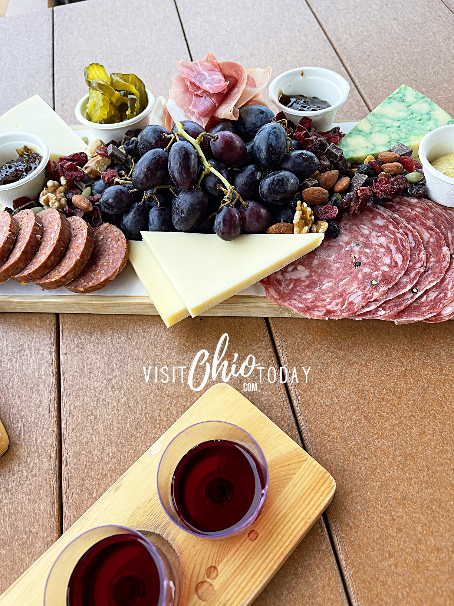 vertical photo of a charcuterie plate and a tasting flight of red wine. Photo credit: Cindy Gordon of VisitOhioToday.com