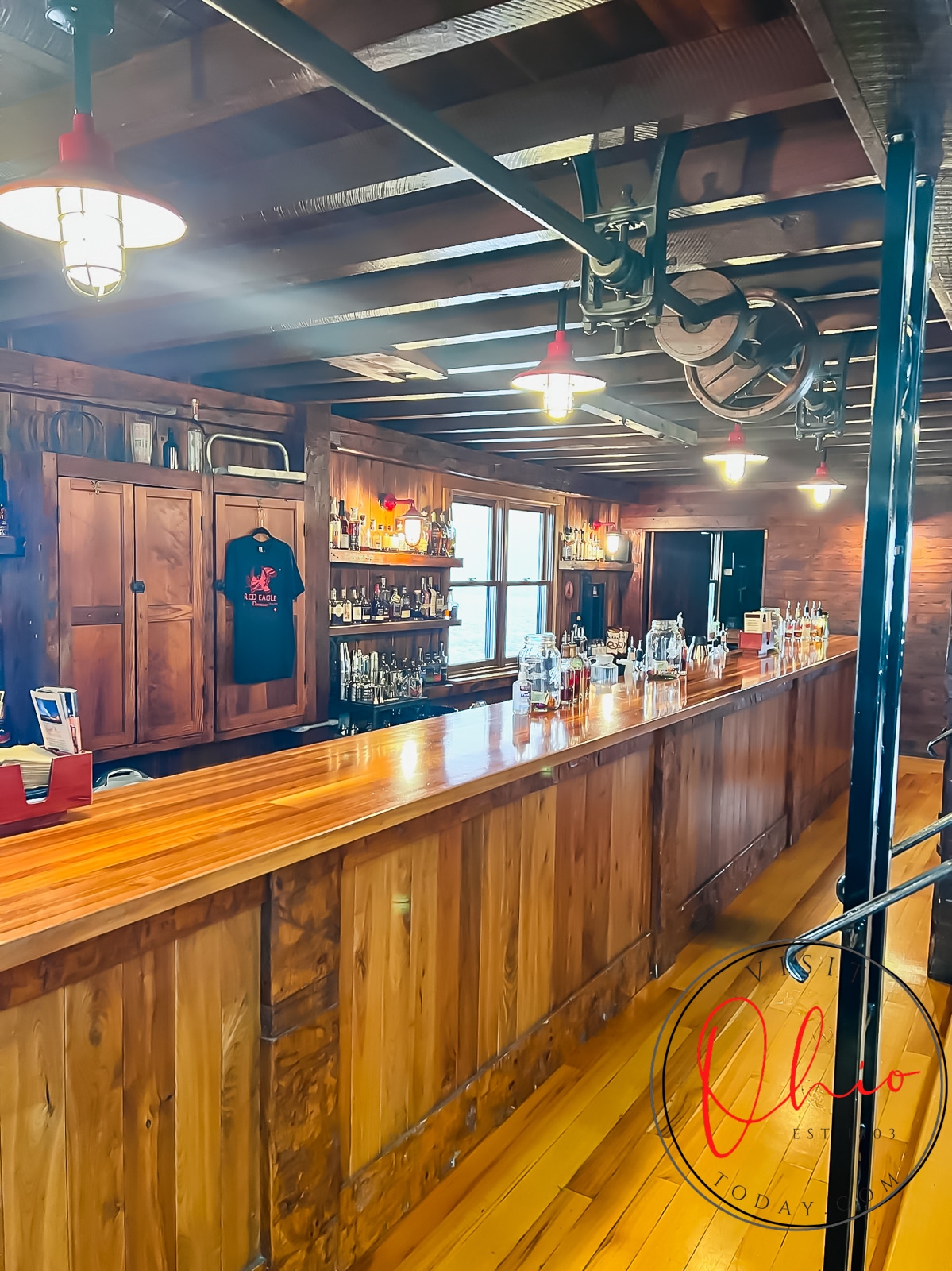 bar made of shiny wood with glass bottles of alcohol on counter Photo credit: Cindy Gordon of VisitOhioToday.com