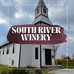 Picture of a tall old white church with a blue sky in the background text overlay: south river winer