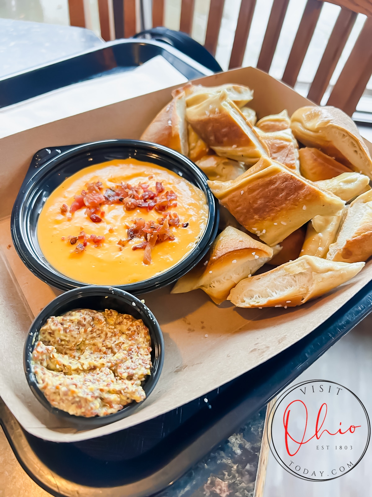 bowl of cheese sauce with crumbled bacon on top and pretzel slices Photo credit: Cindy Gordon of VisitOhioToday.com