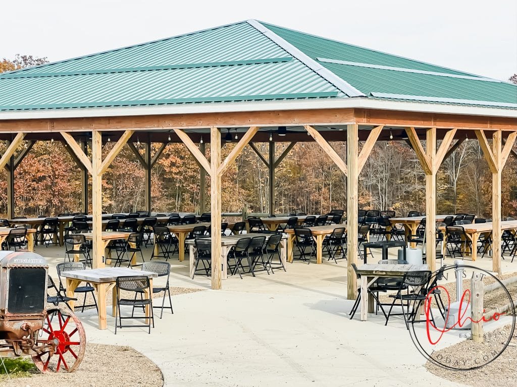 outdoor pavilon with wood tables and black chairs. Pavilon had green tin roof Photo credit: Cindy Gordon of VisitOhioToday.com