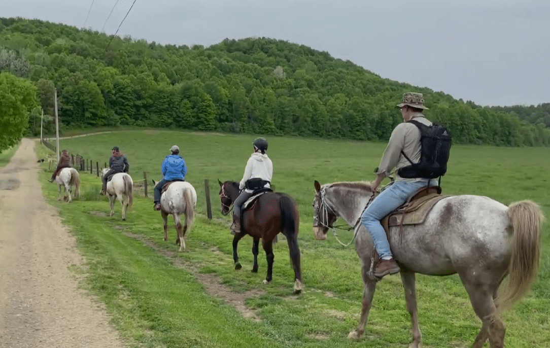 horizontal photo of some horseback riders on a tour with Spotted Horse Ranch