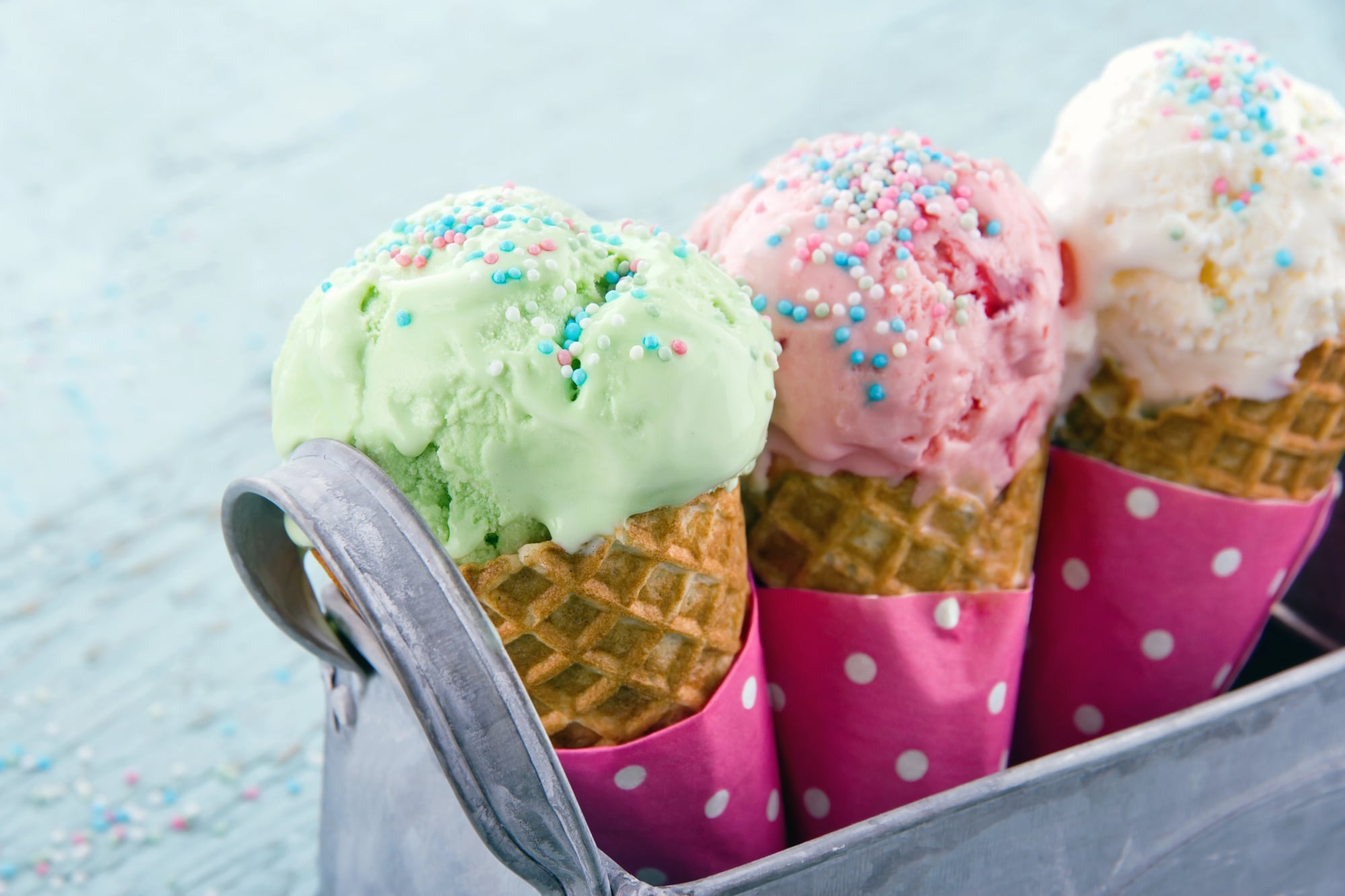 horizontal photo of three ice cream cones in a metal container