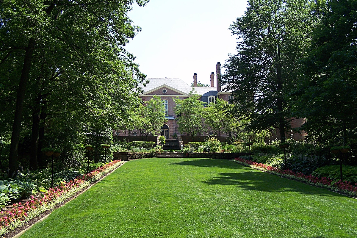 horizontal photo of Kingwood Center Garden showing a well manicured lawn with the hall in the background