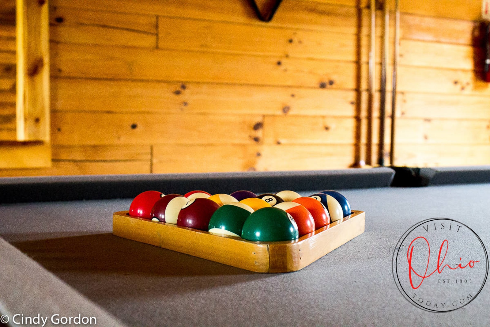 pool table with balls racked in triangle on table