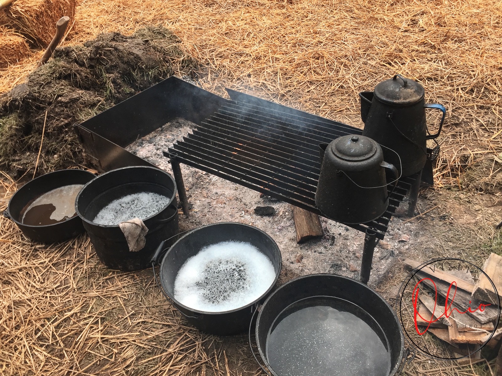 old firepit stove with cast iron pans filled with liquid at ohio vilage