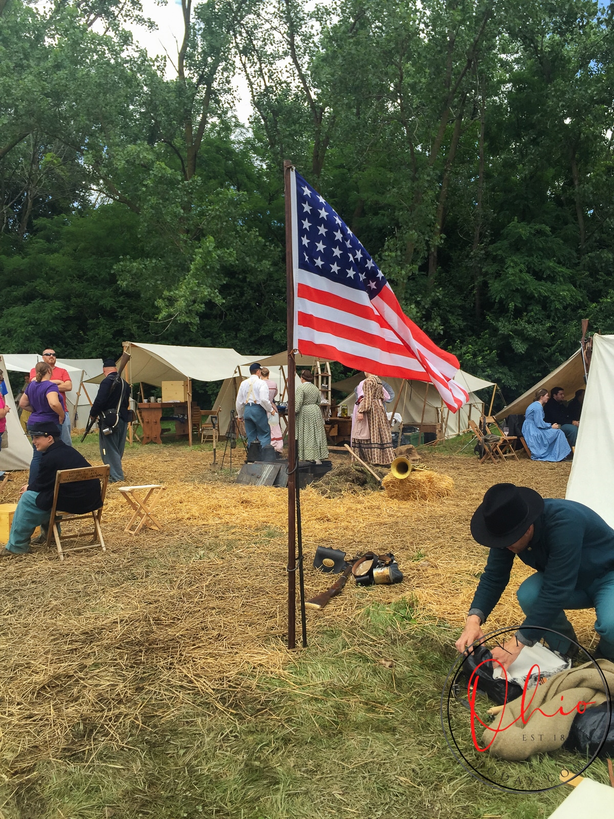 american flag at ohio village in front of tents Photo credit: Cindy Gordon of VisitOhioToday.com