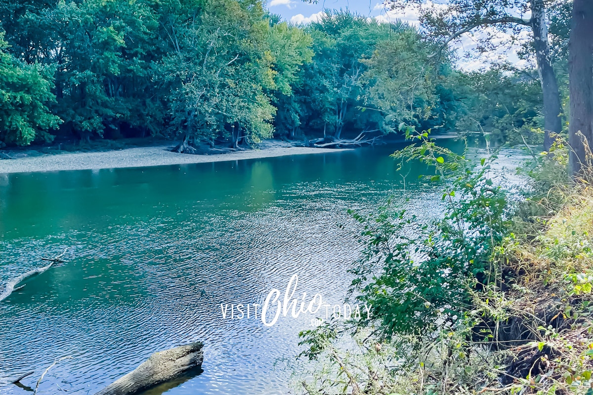picture of a blue river with blue sky and white clouds and green trees in background Photo credit: Cindy Gordon of VisitOhioToday.com