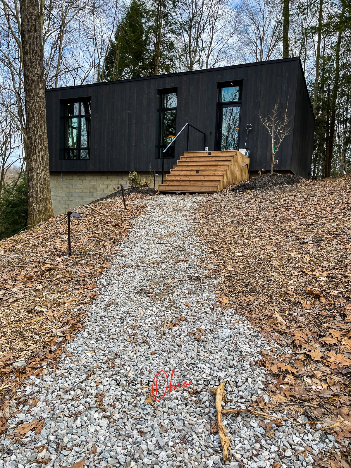 Idyll Reserve - The Hillside at top of picture. Black building with wooden steps, gravel path leading to cabin Photo credit: Cindy Gordon of VisitOhioToday.com