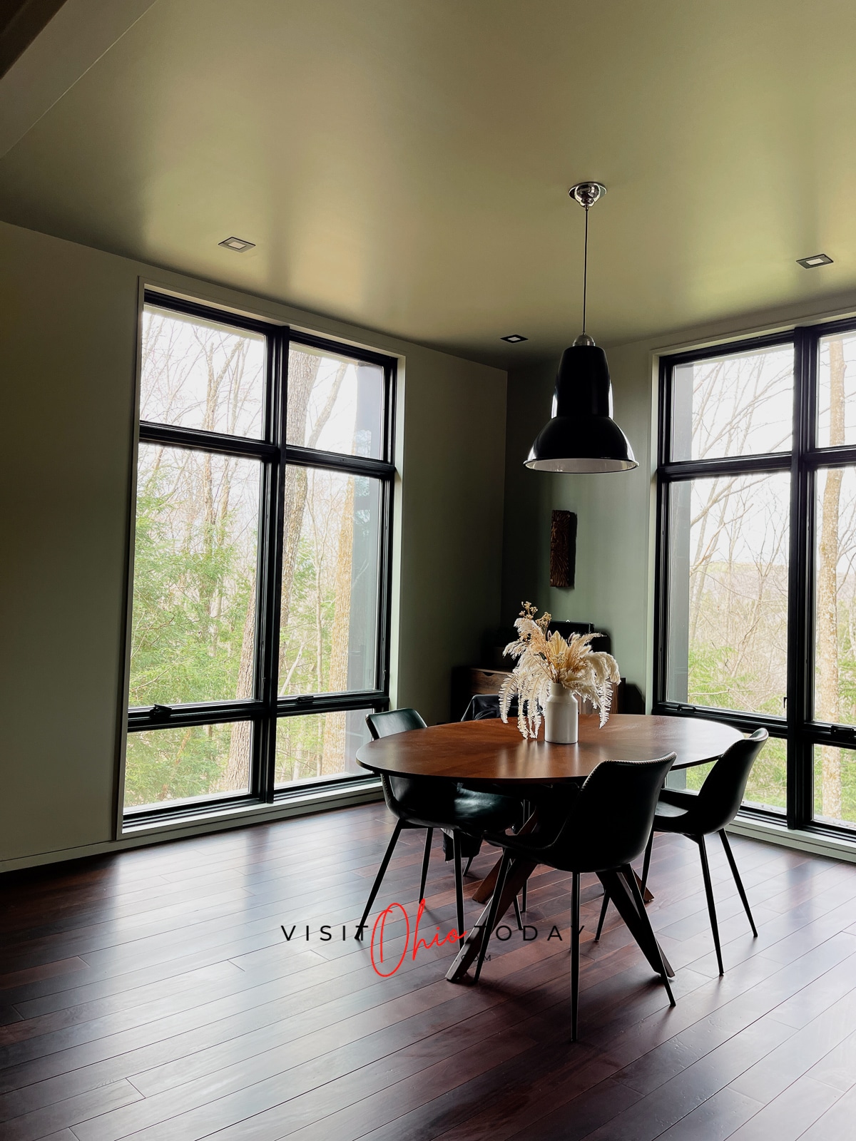 two walls of windows with wooden table and four chairs in center of picture white feathery things in vase on table Photo credit: Cindy Gordon of VisitOhioToday.com