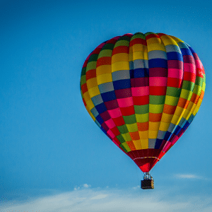 A brightly coloured hot air balloon in flight