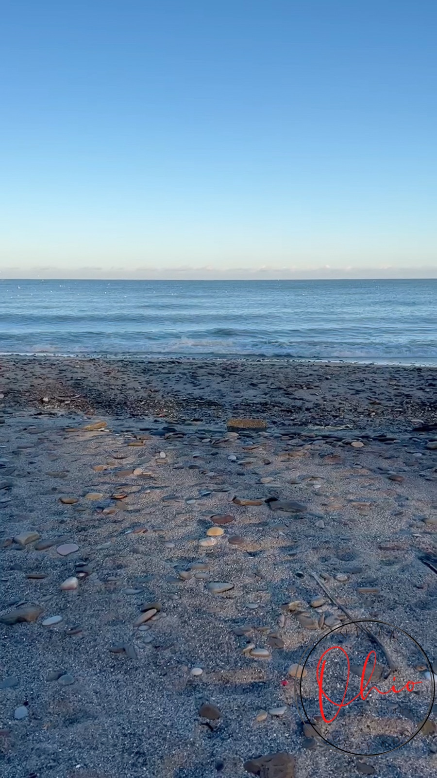 A beach scene of blue sky and blue sea