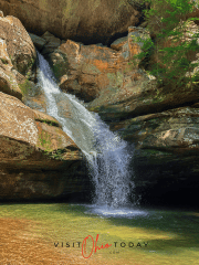 unobstructed view of cedar falls waterfall, water flowing down rocks into a clear pool