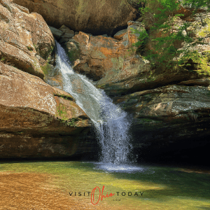 unobstructed view of cedar falls waterfall, water flowing down rocks into a clear pool