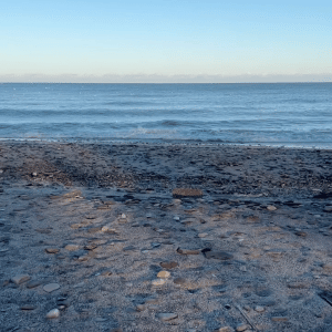 A beach scene of blue sky and blue sea