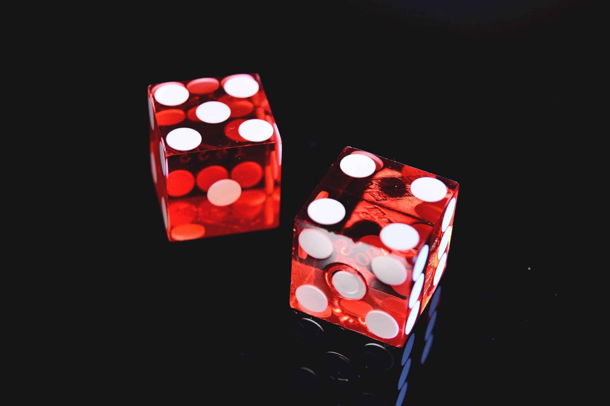 A pair of red dice on a black background
