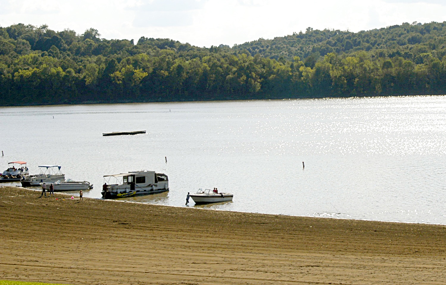 horizontal photo of the lake at Dillon State Park with moored boats along the shoreline