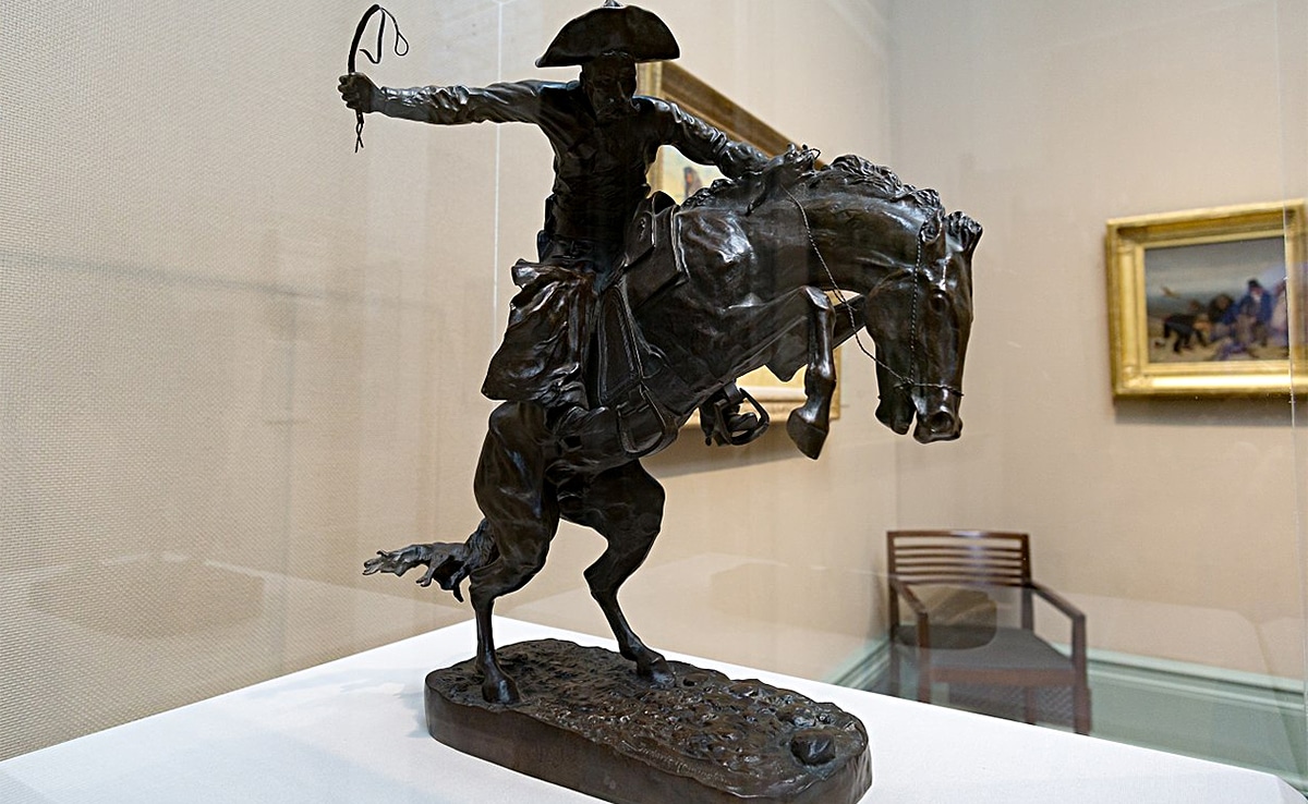 Horizontal photo of a bronze sculpture called The Bronco Buster, by Frederic Remington in 1895. Image credit: Frederic Remington, Public domain, via Wikimedia Commons