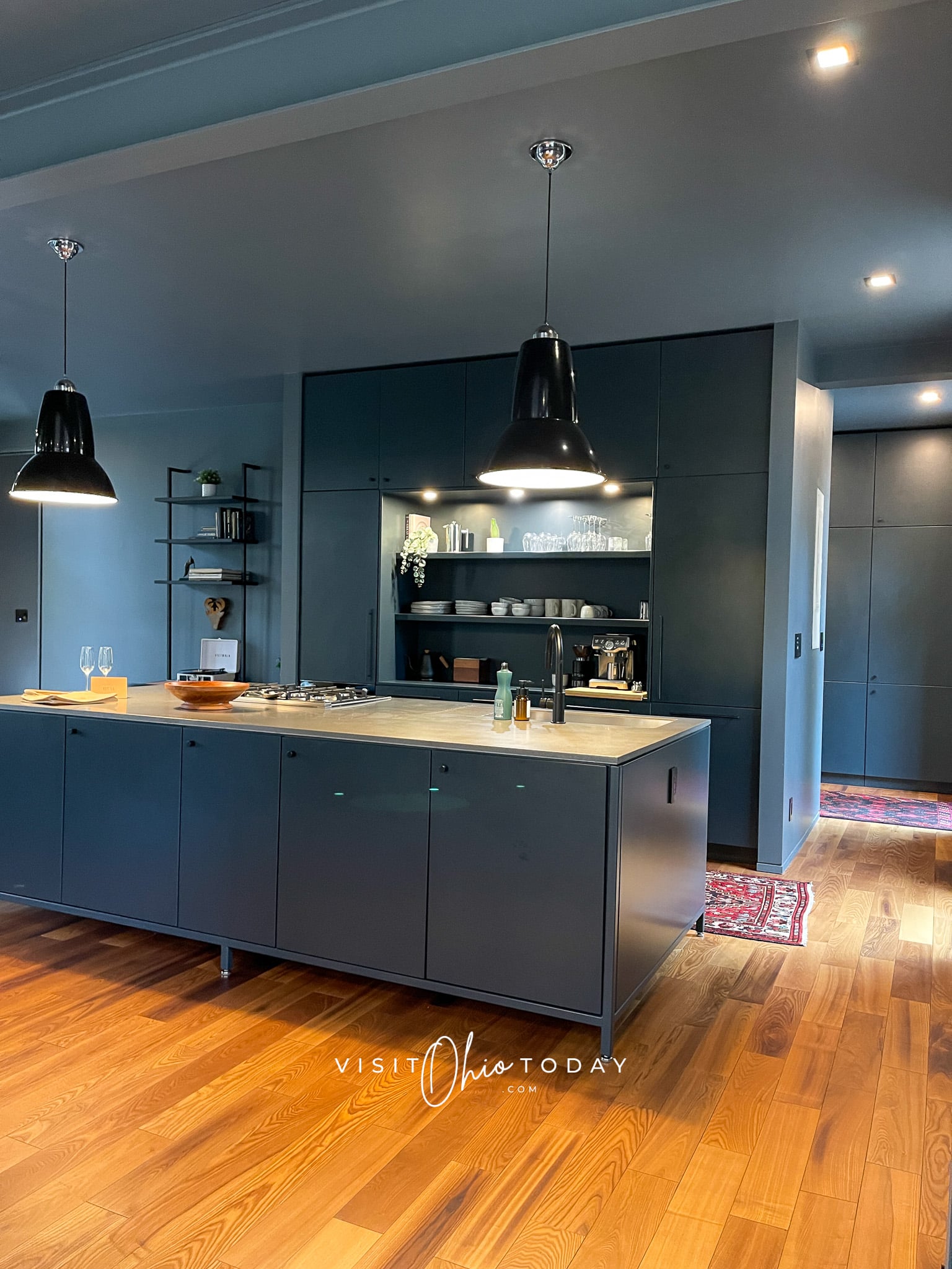 moody blue kitchen with blue cabinets and big blue counter top