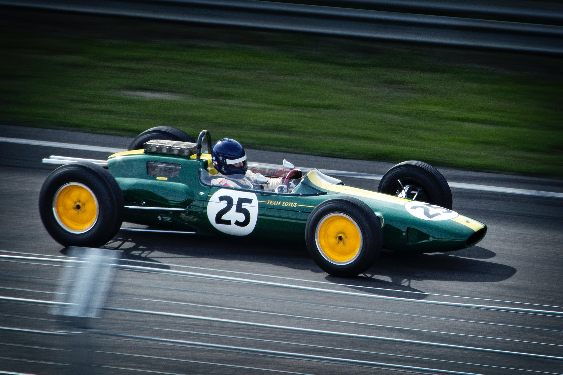 A green racing car with the number 25 on the side