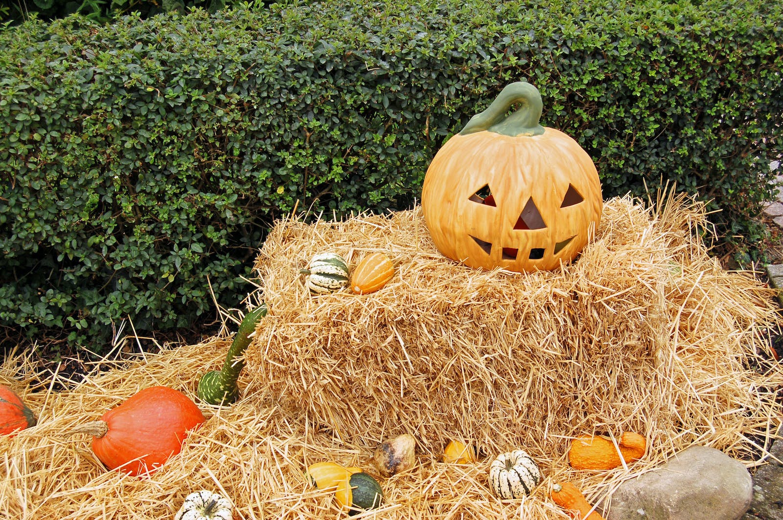 A large carved pumpkin sat on a hay bale