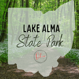 Trees in a forest with an Ohio map silhouette. Text overlay says Lake Alma State Park