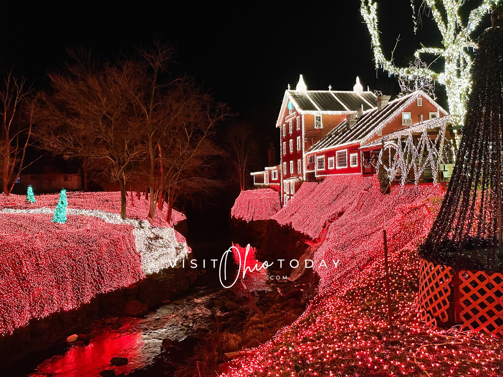 view of clifton mill christmas lights both sides of bank