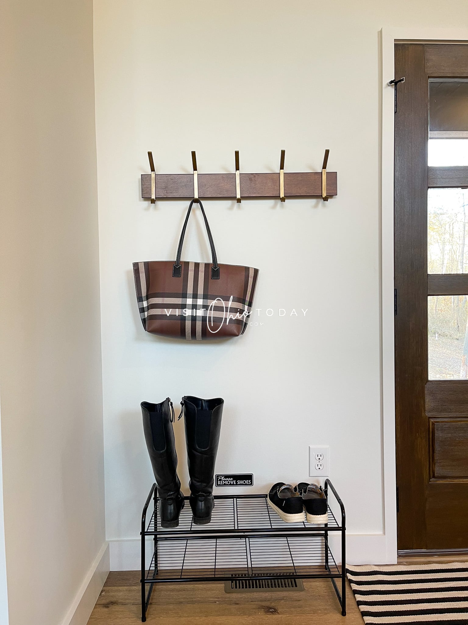 entry way of house with brown striped purse hanging on hook, boots and shoes on a shoe rack Photo credit: Cindy Gordon of VisitOhioToday.com
