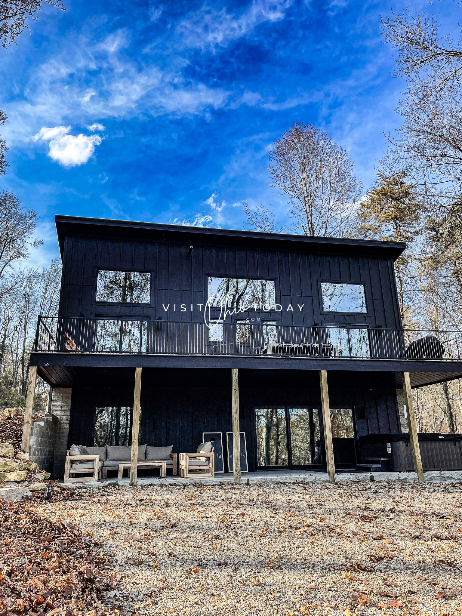 picture of a black two story cabin in the woods with leaves on ground Photo credit: Cindy Gordon of VisitOhioToday.com