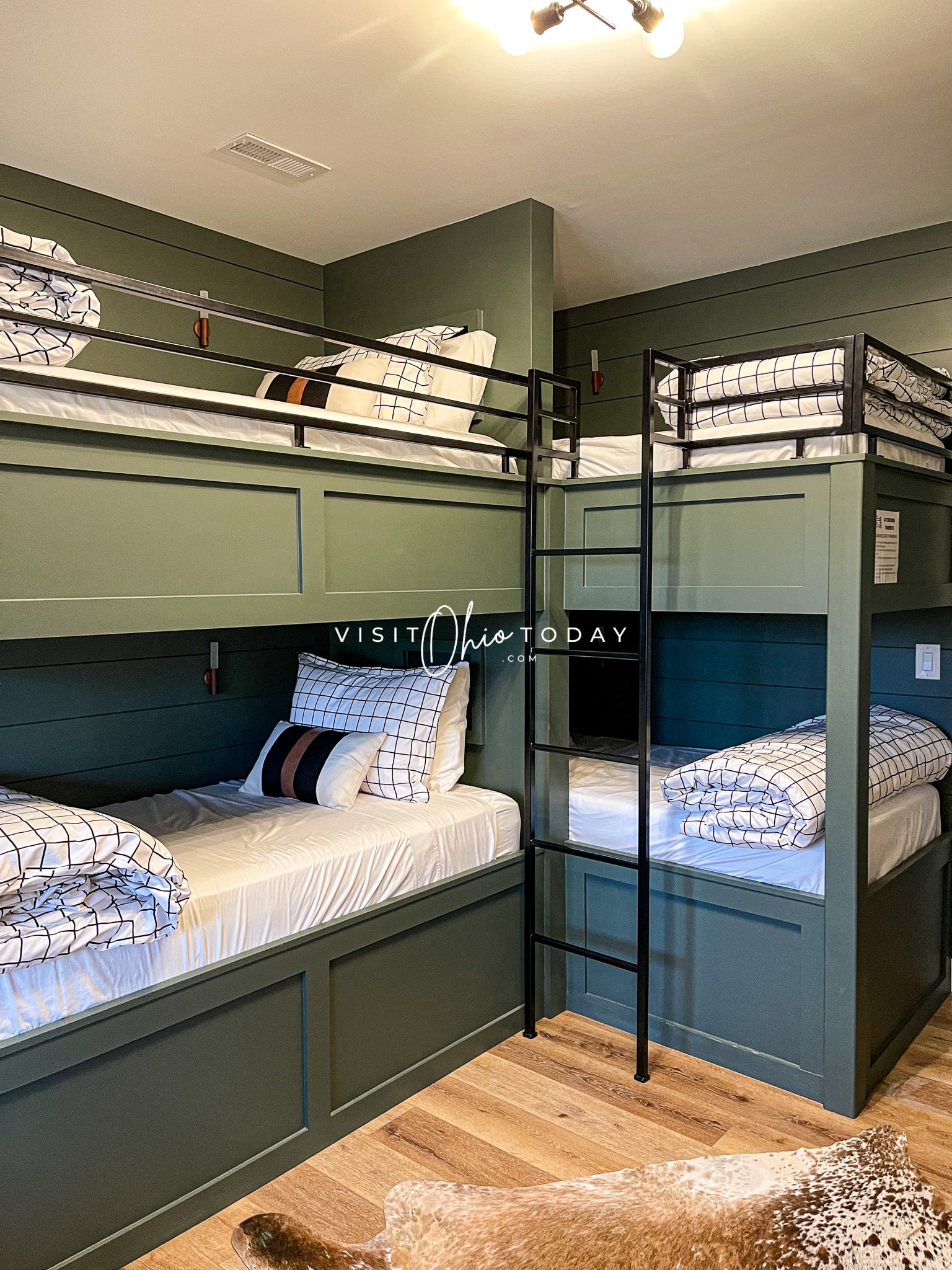 2 sets of green wooden bunk bed with rod iron ladders Photo credit: Cindy Gordon of VisitOhioToday.com