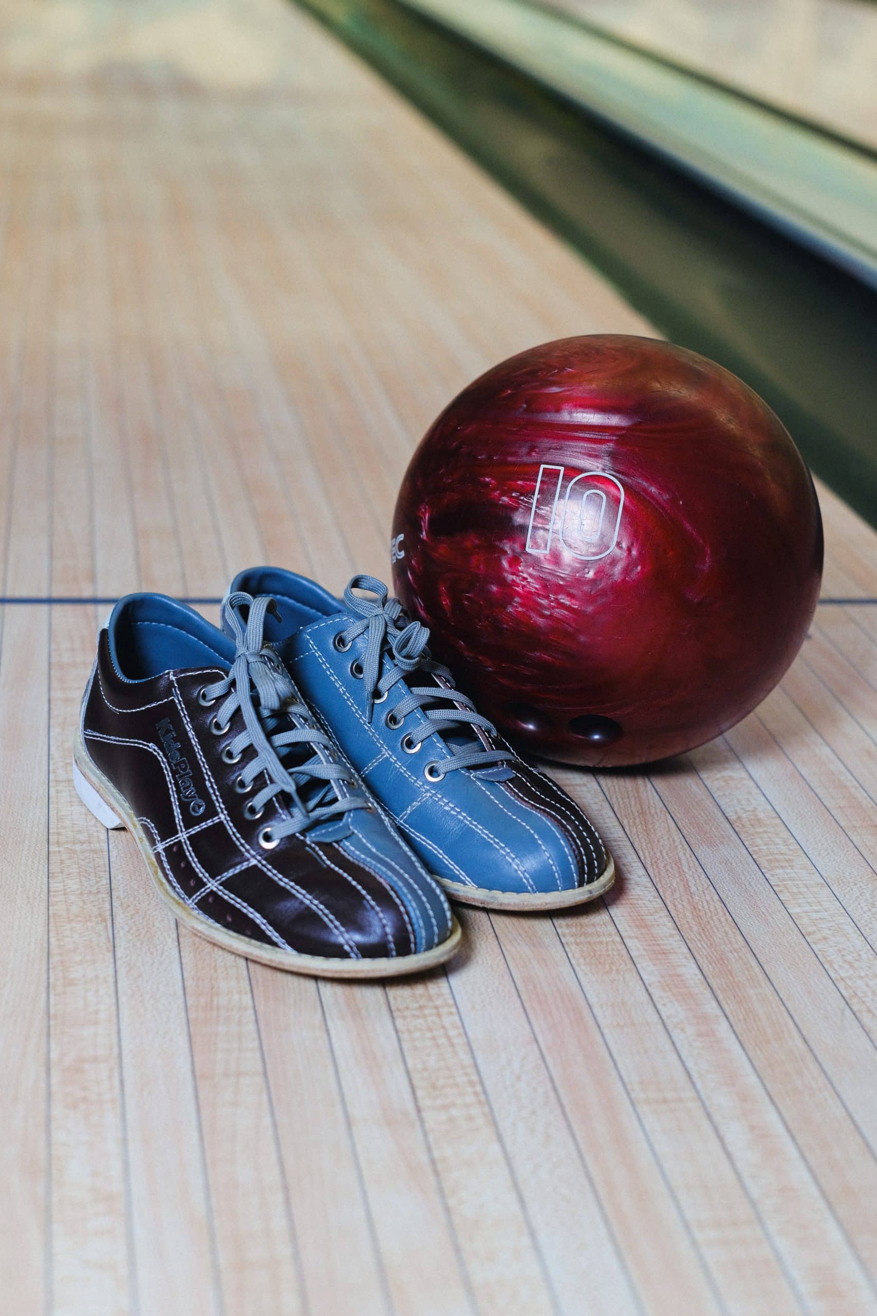A red bowling ball and pair of blue bowling shoes
