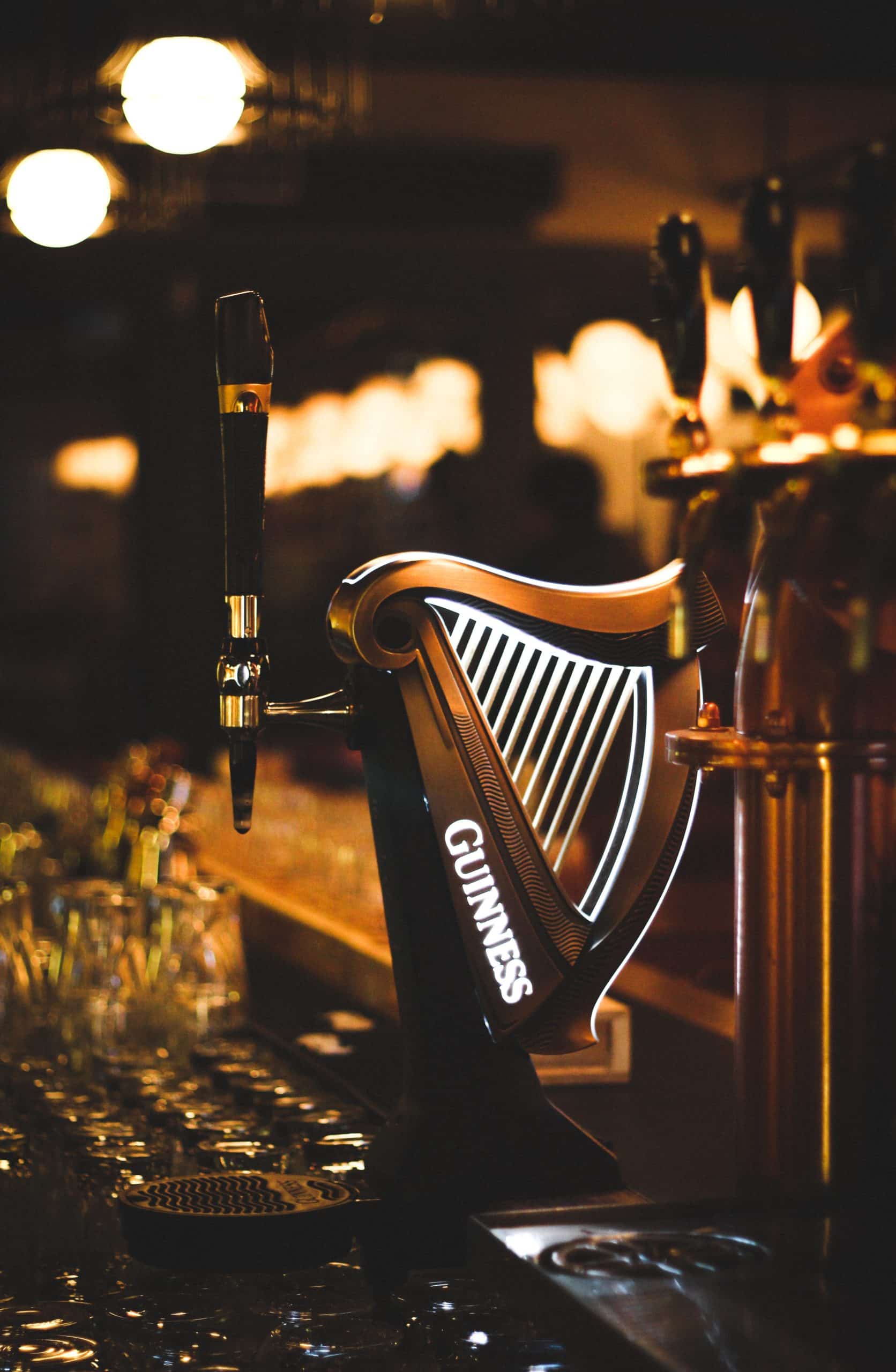 A themed beer pump in the shape of a harp with the word Guinness on the side