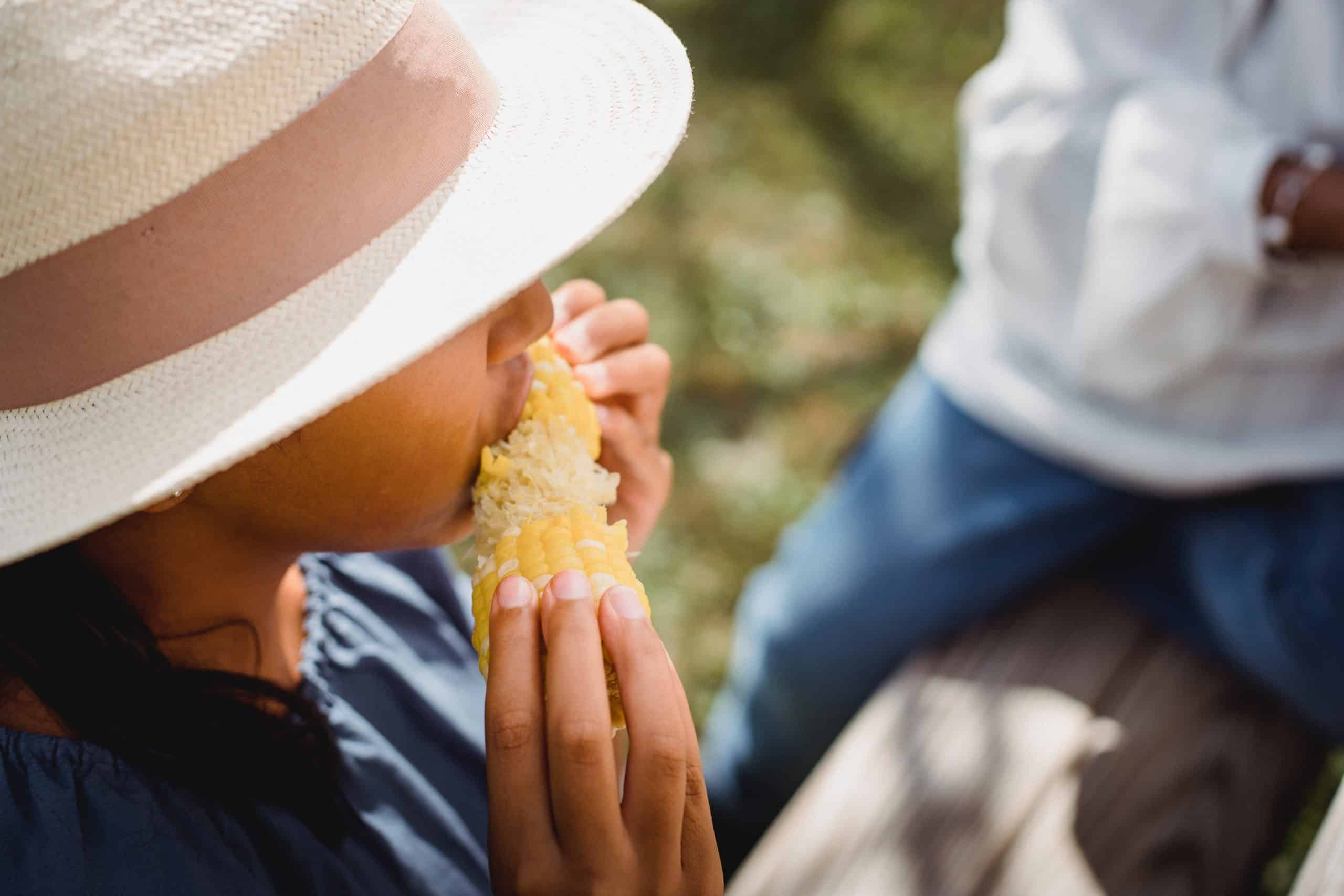 A female enjoying corn on the cob