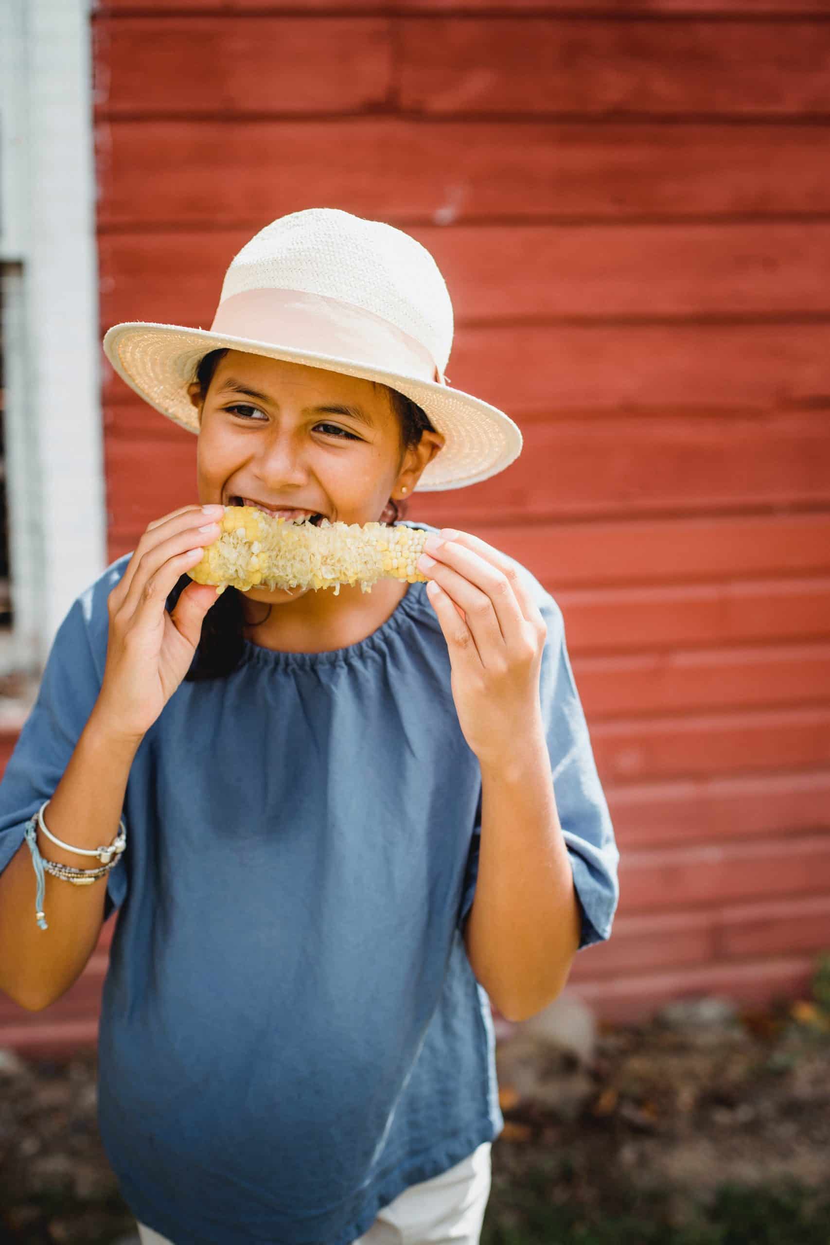 A female enjoying some corn on the cob