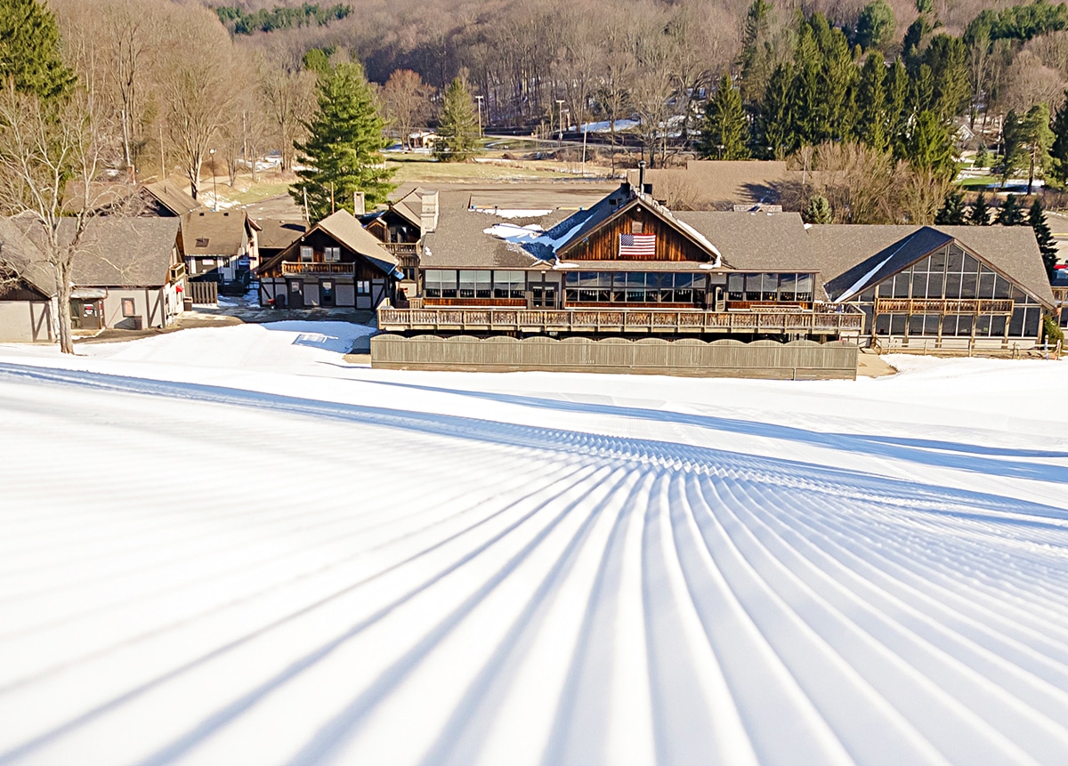 horizontal image of the Snow Trails building with ploughed snow slope in front of it