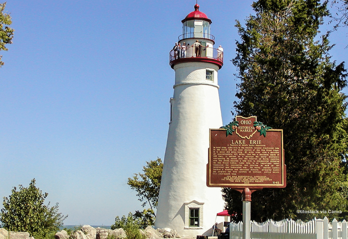 horizontal photo of Marblehead Lighthouse with its historical marker in the forground