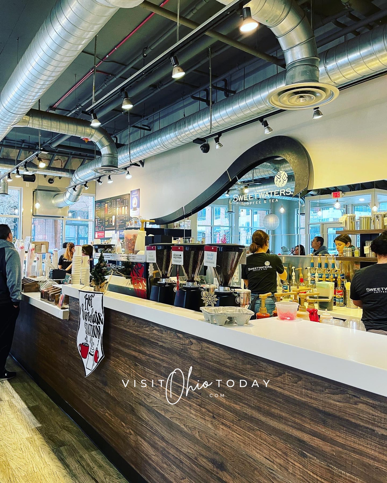 inside of a busy coffee shop. Shows white counter with workers busy behind it making drinks for customers Photo credit: Cindy Gordon of VisitOhioToday.com