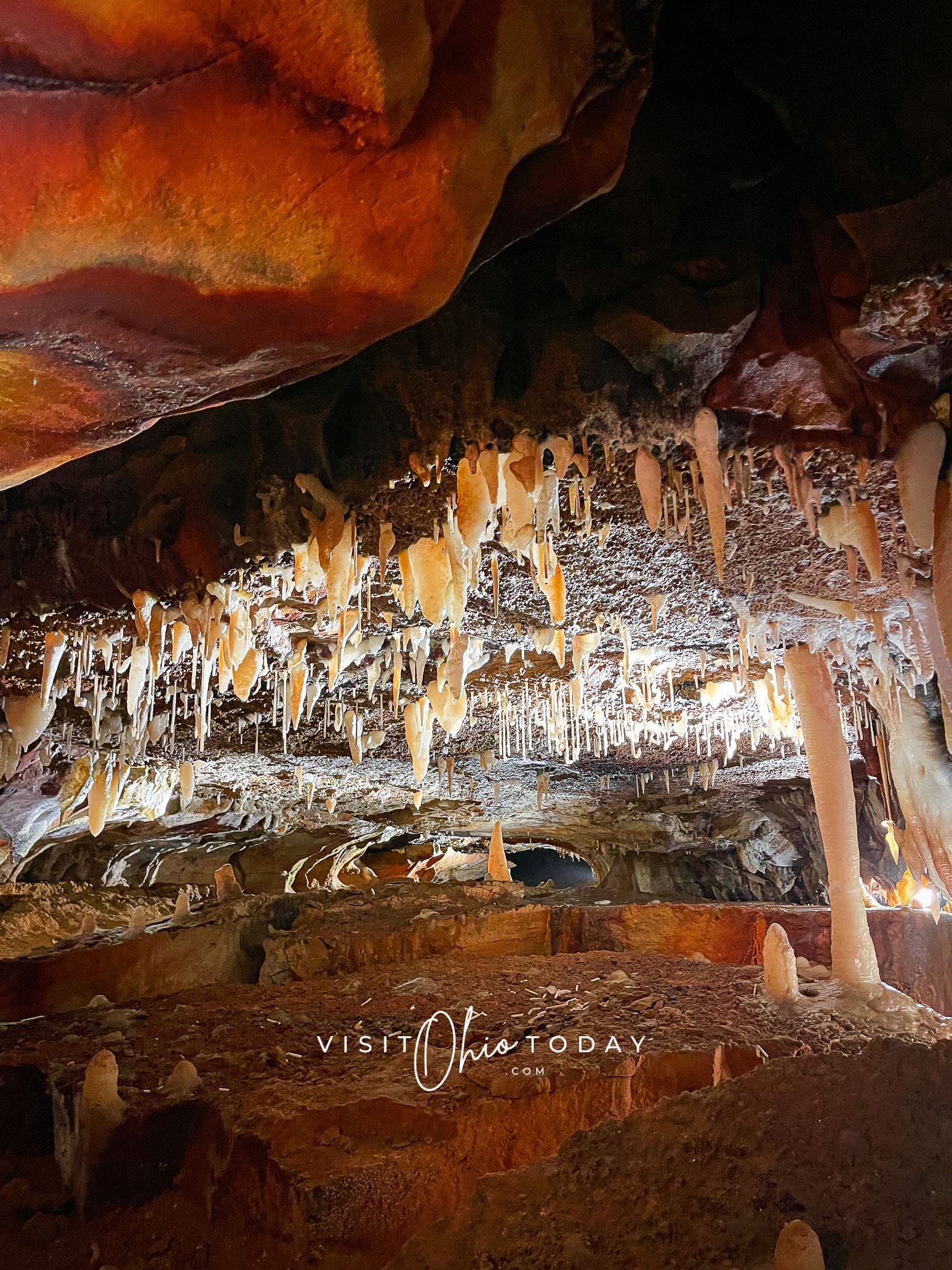 A photo of stalagmites and stalactites inside a cave
