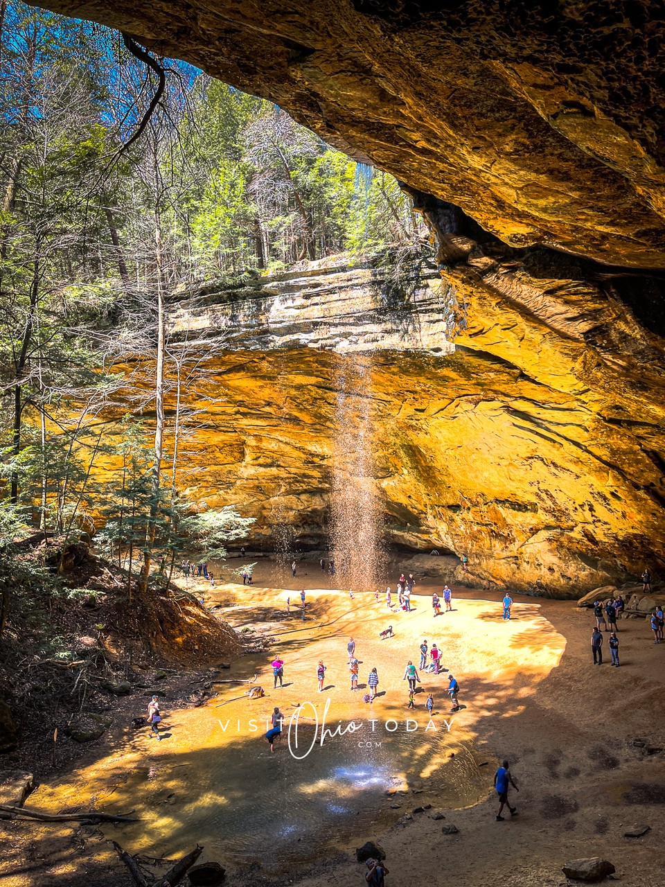 Water falling into a river below. Lots of people are stood around admiring the view. Photo credit: Cindy Gordon of VisitOhioToday.com