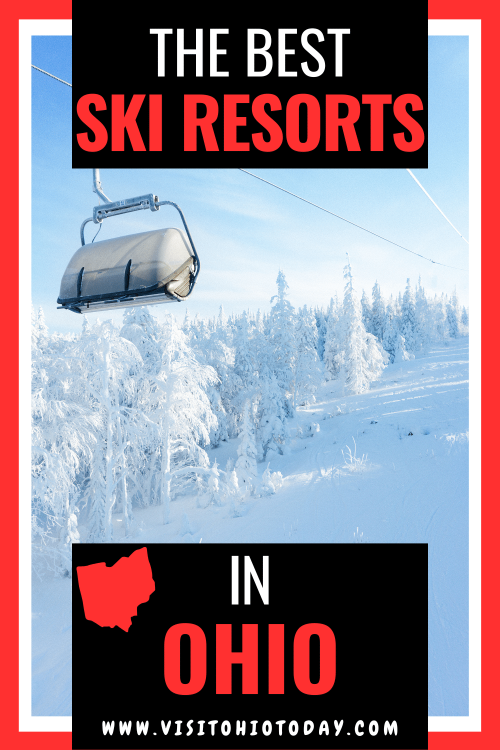 Vertical photo of a ski lift going up a snow-covered hill. There are snow-covered trees in the background