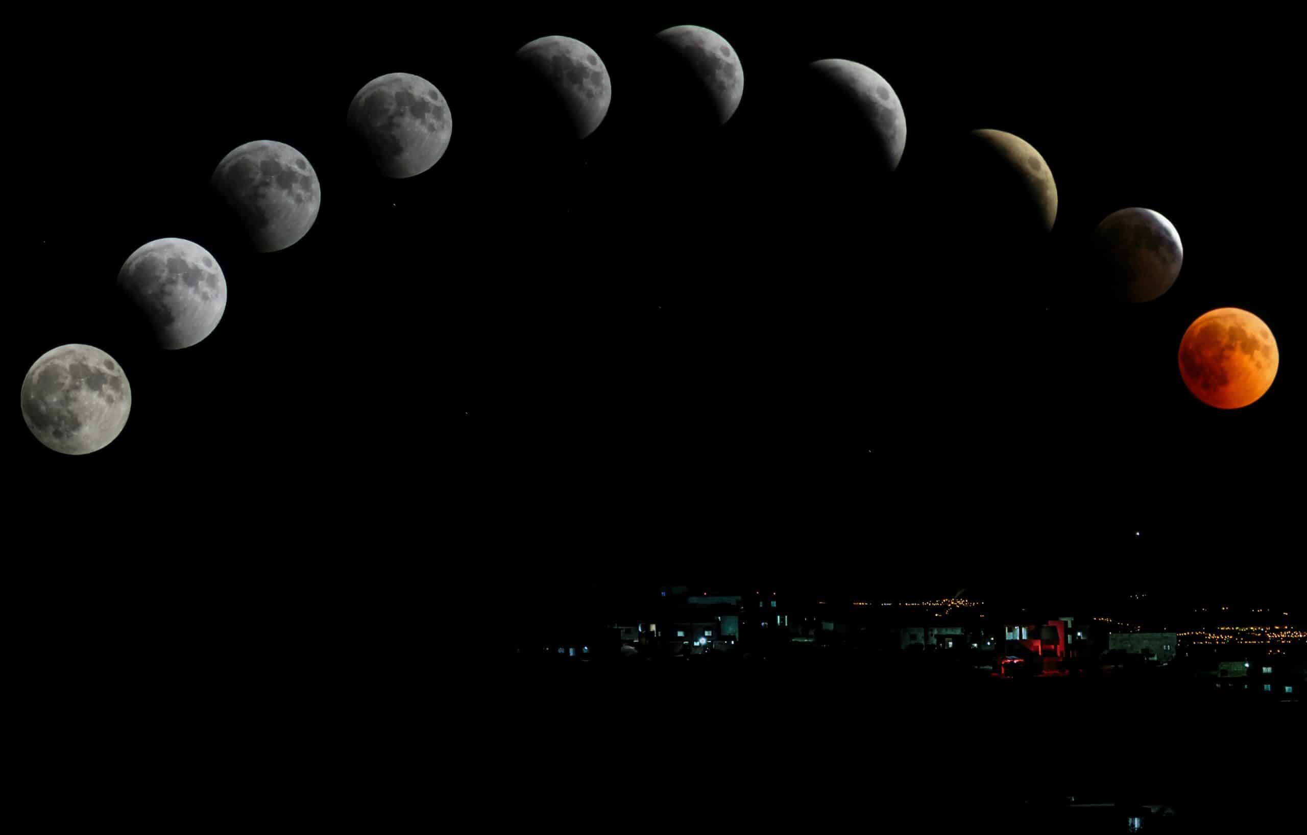 An image of moon phases in a curved line in the sky