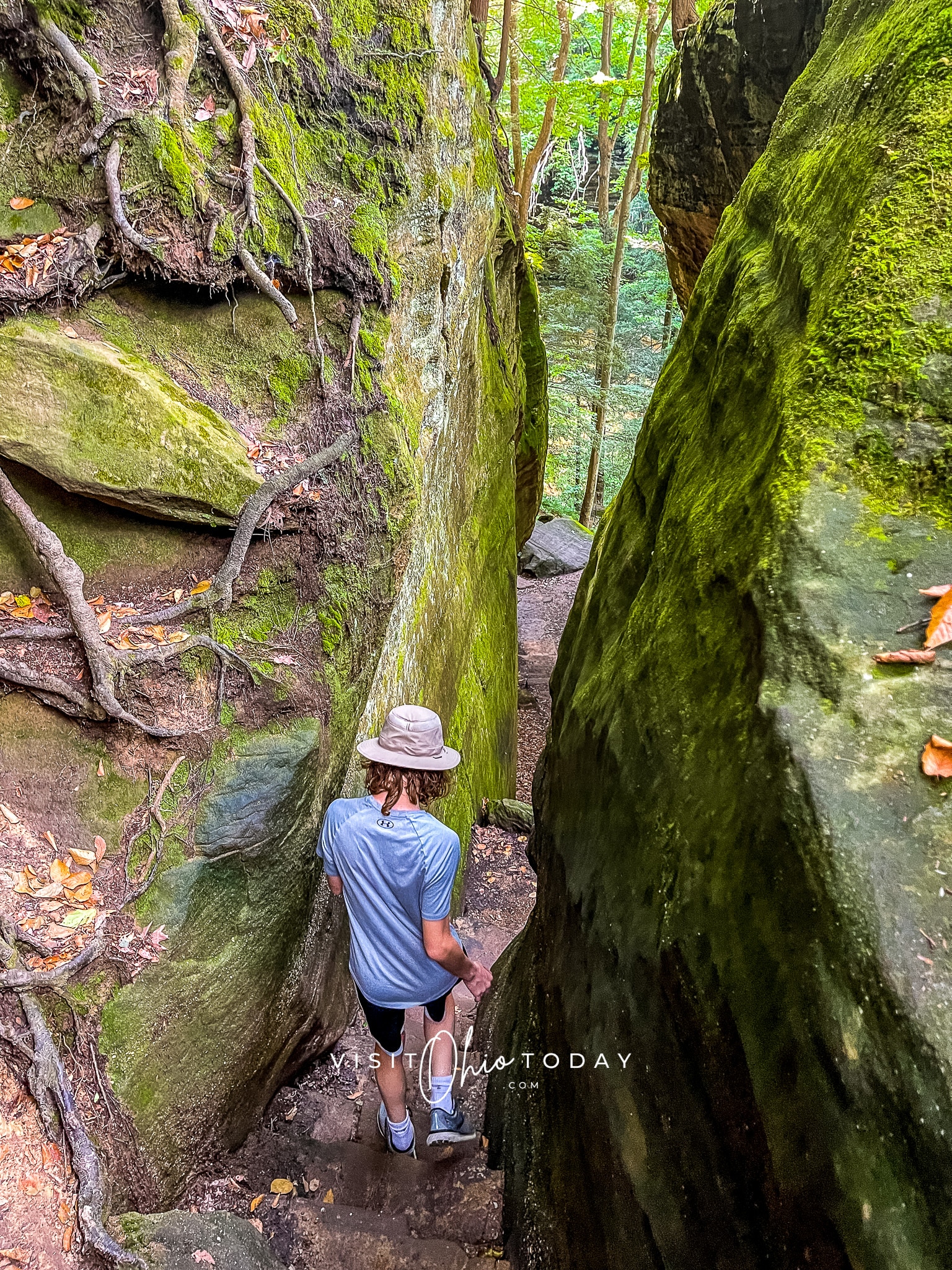 A young male walking down the area known as "Fat Lady's Squeeze" at Cantwell Cliffs in Hocking Hills