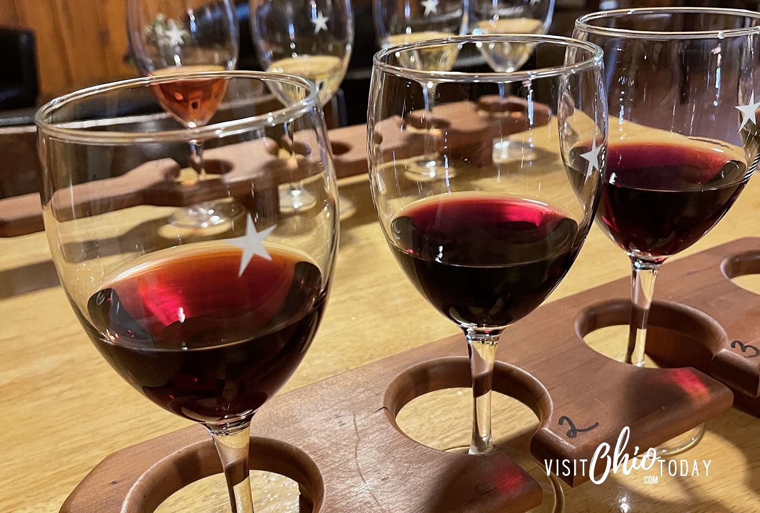 horizontal photo of a flight of red wine in a wooden stand. Photo credit: Cindy Gordon of VisitOhioToday.com