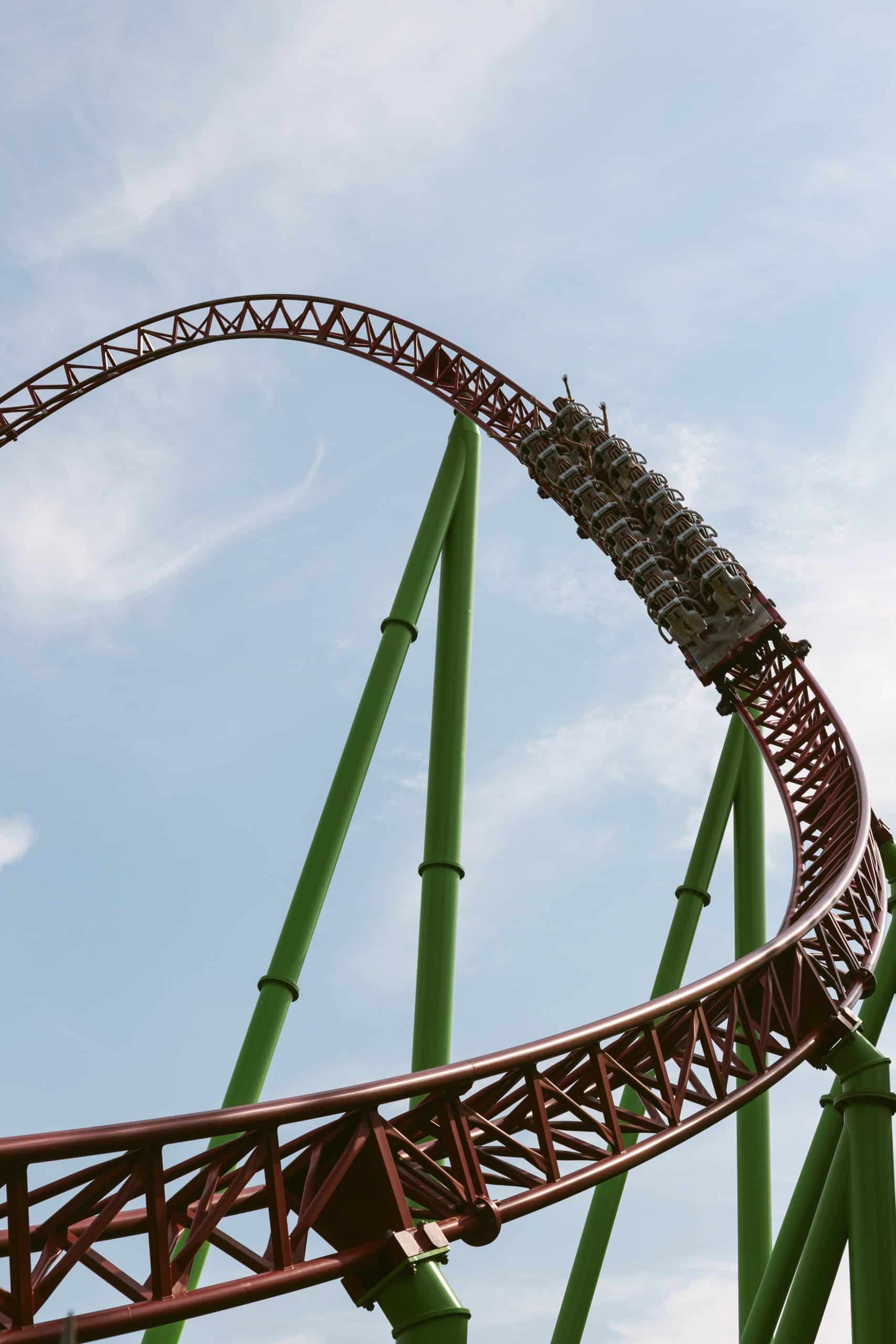 A roller coaster on green legs with a red track