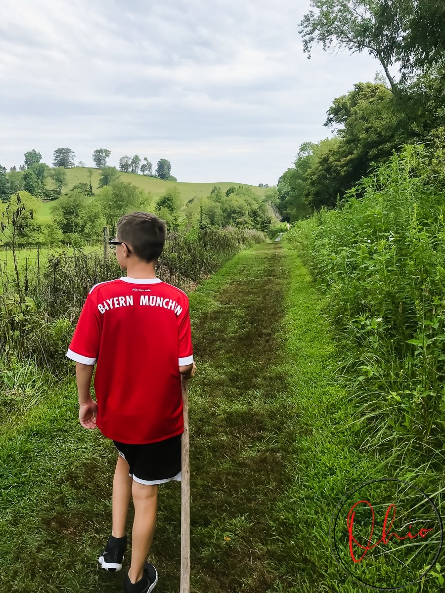 vertical photo of a boy walking along the trail at Rockbridge State Photo credit: Cindy Gordon of VisitOhioToday.com Nature Preserve