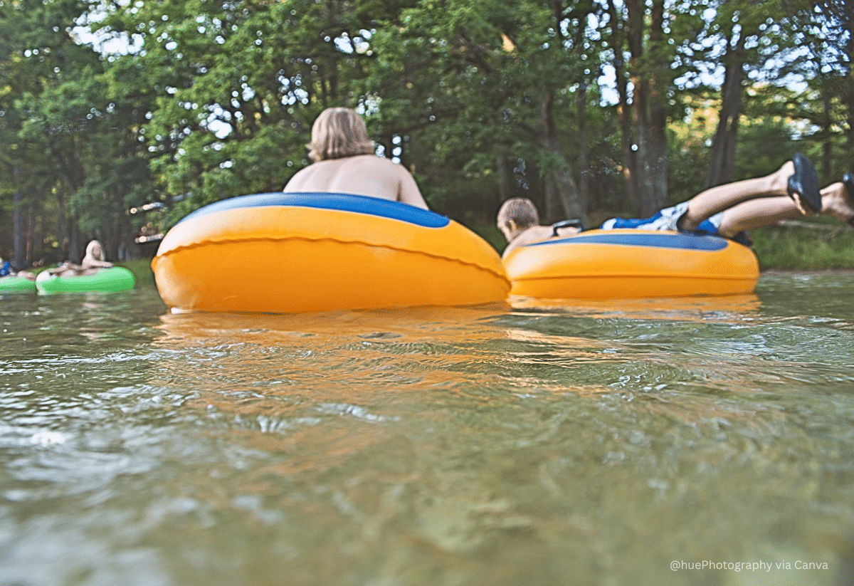 horizontal photo of some kids river tubing on the river